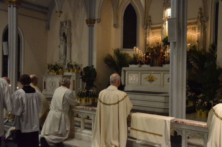 Priests kneel at the altar