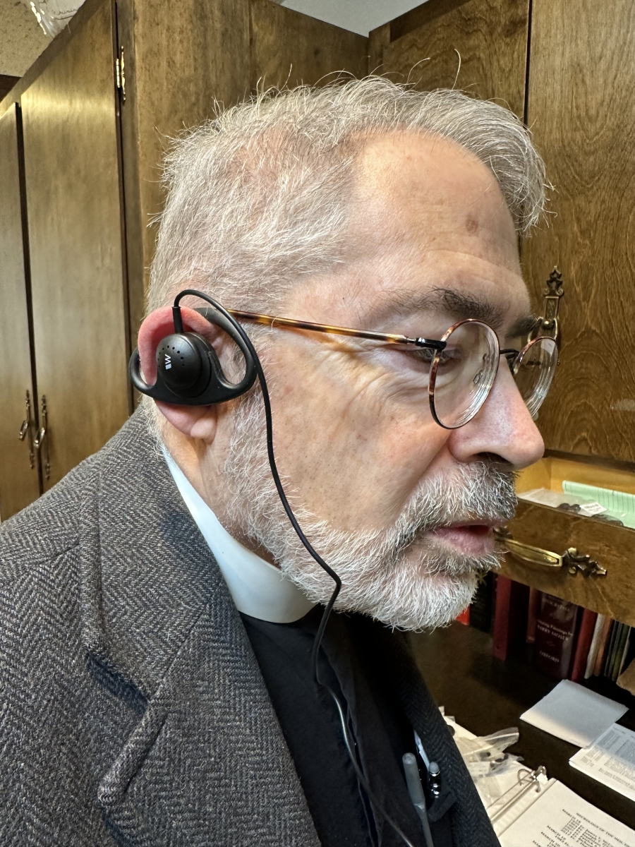 man wearing listening assist device