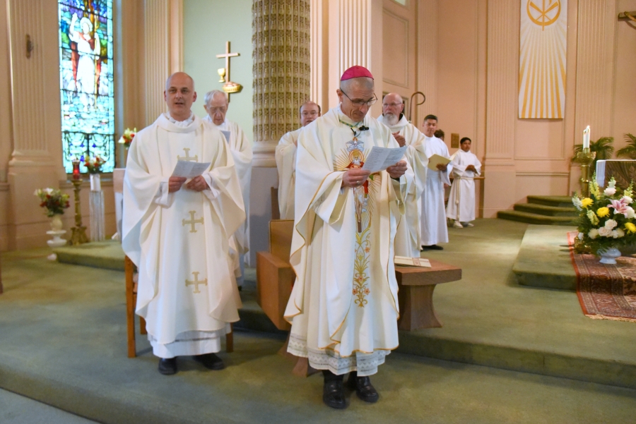 Bishop James Ruggieri with Father Seamus Griesbach and other priests