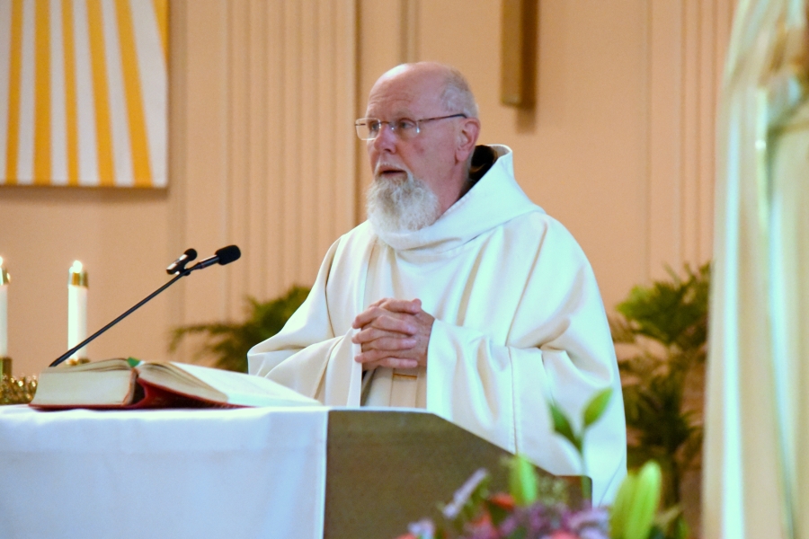Father Michael Seavey reads the Gospel.