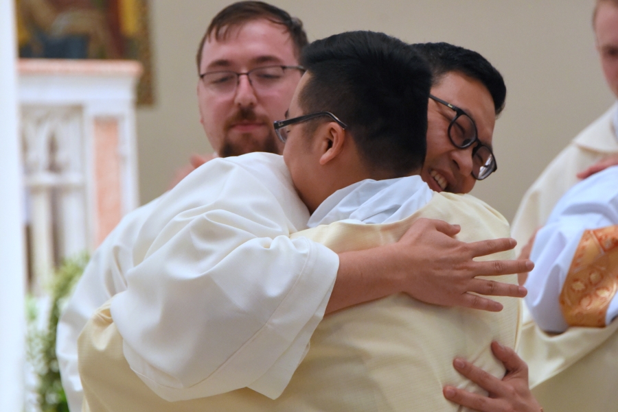 Deacon Thanh Duc Pham receives a hug.