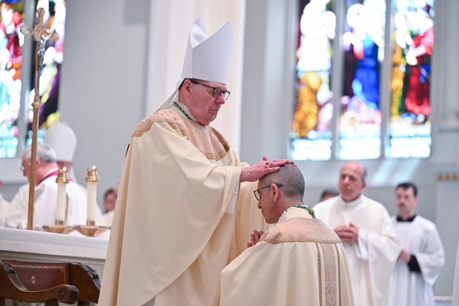 Bishop Richard Henning lays hands on Bishop James Ruggieri.