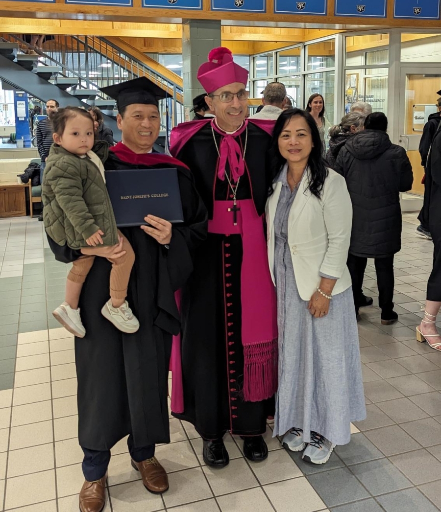 Bishop with a graduate and family