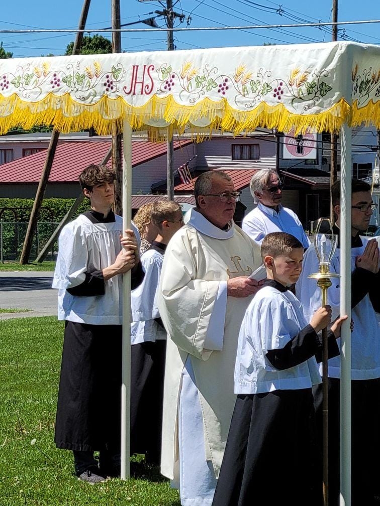 praying in the Corpus Christi Procession