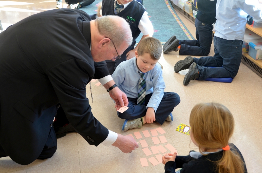 Bishop Deeley playing a game with schoolchildren.