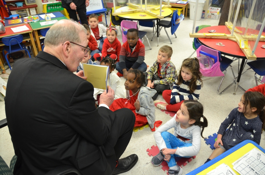 Bishop Deeley reading to schoolchildren.