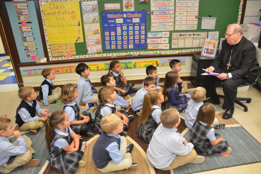 Bishop Deeley reading to schoolchildren.