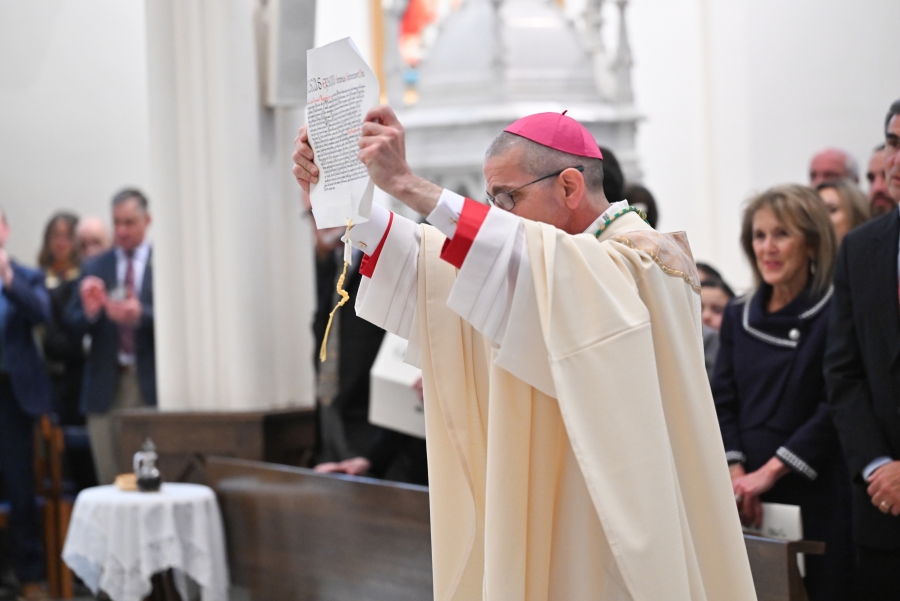 Bishop Ruggieri displays the papal bull naming him as bishop of Portland.