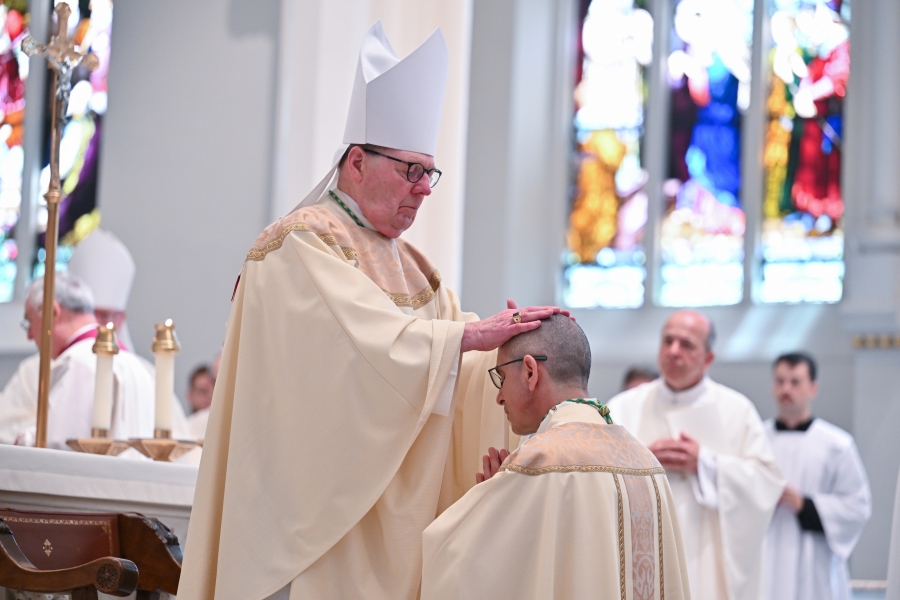 Bishop Robert Deeley lays hands on Bishop James Ruggieri.