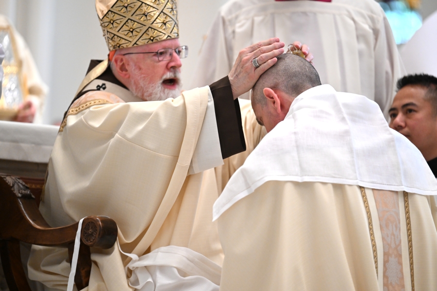 Cardinal O'Malley anoints Bishop Ruggieri's head with oil.