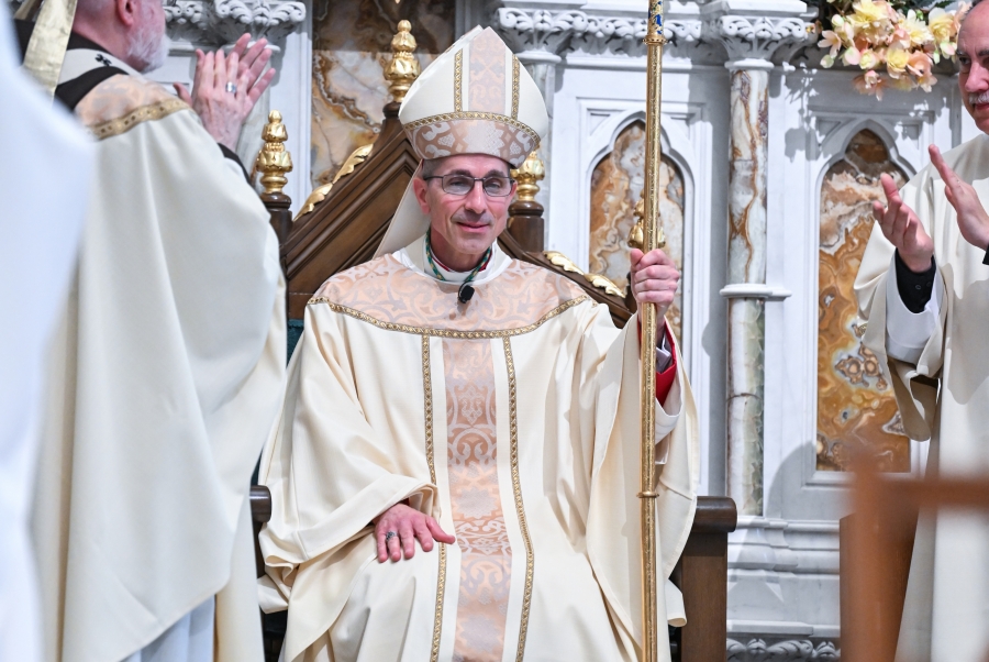 Bishop Ruggieri sits in the cathedra and is installed as bishop of Portland.
