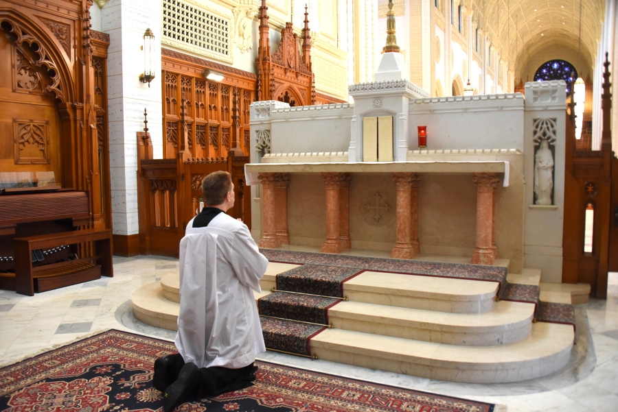 Brian Wilson kneels before the tabernacle.