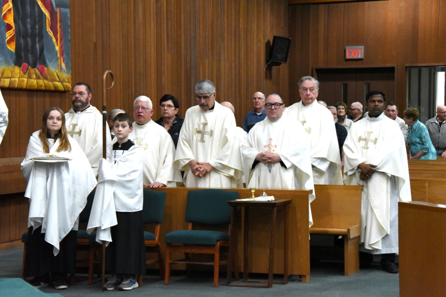 Priests with a connection to the parish gather for the Mass