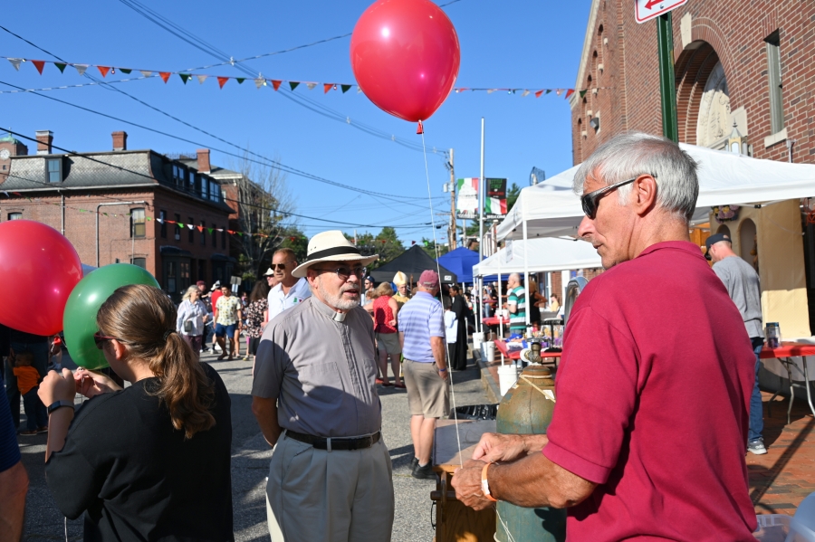 Blowing up a red balloon.