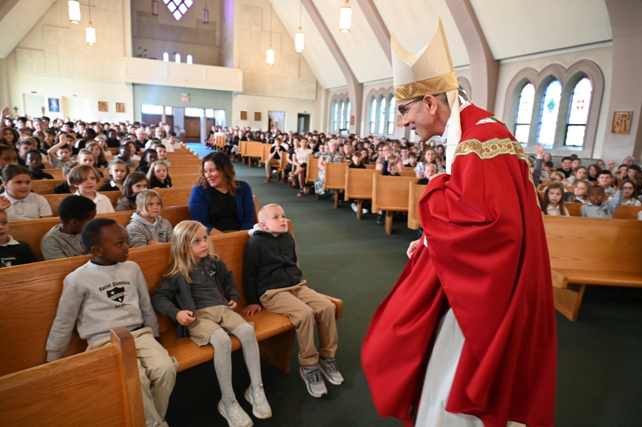 Bishop Ruggieri talking to students during Mass