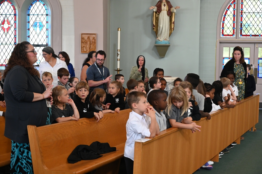 students sitting in church pews 