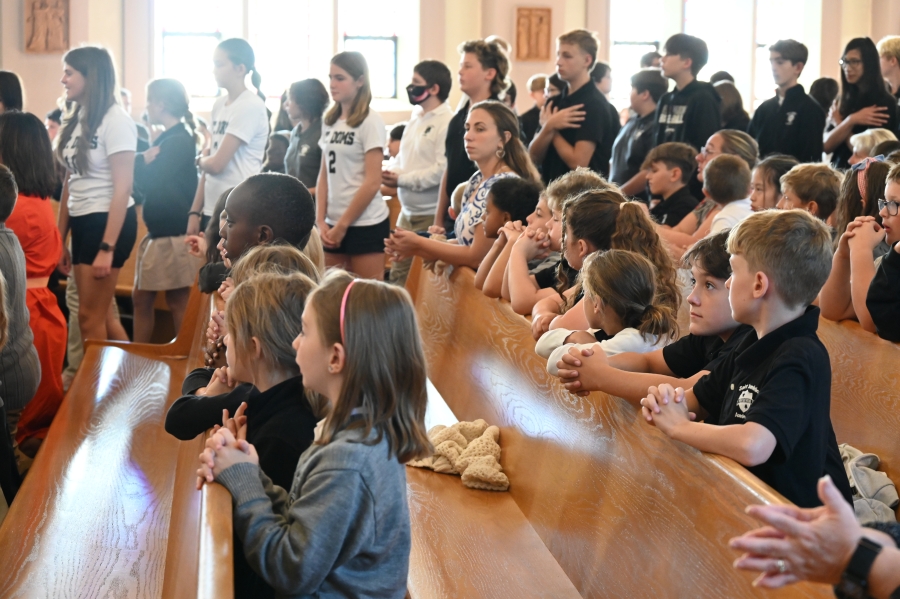 students praying during Mass