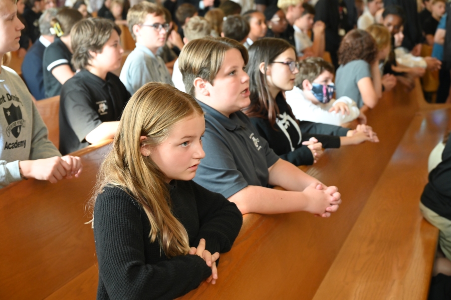 Students praying in pews