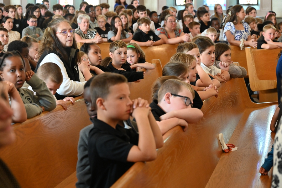 Students praying in pews