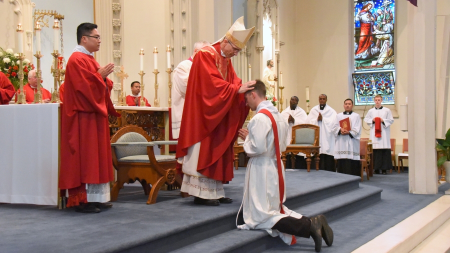 Bishop James Ruggieri lays hands on Deacon Matthew Valles.