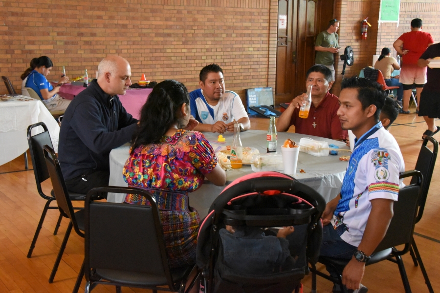 Father Seamus Griesbach and other diners at a table.