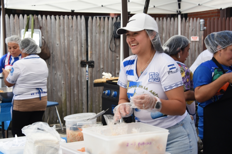 Jocelyn Alvarez serves a pupusa.