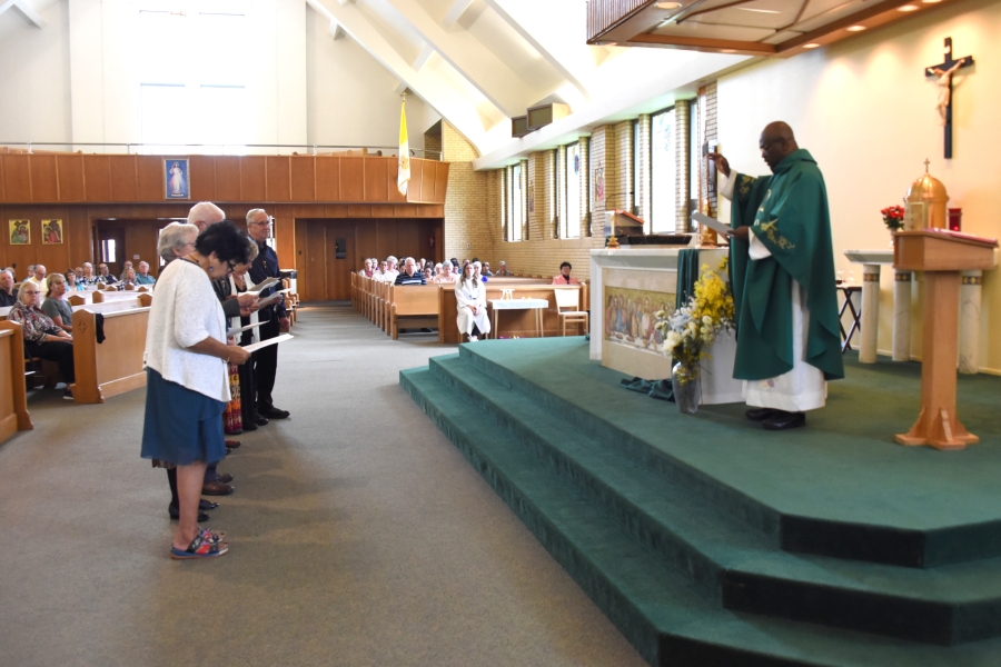 Father Patrick Agbodi blesses members of the St. John the Baptist Franciscan Fraternity.