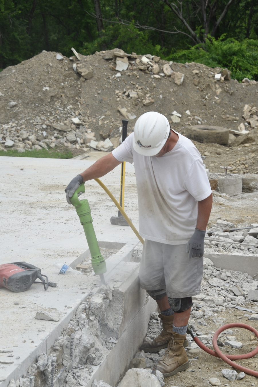 Jackhammering one of the old walls.