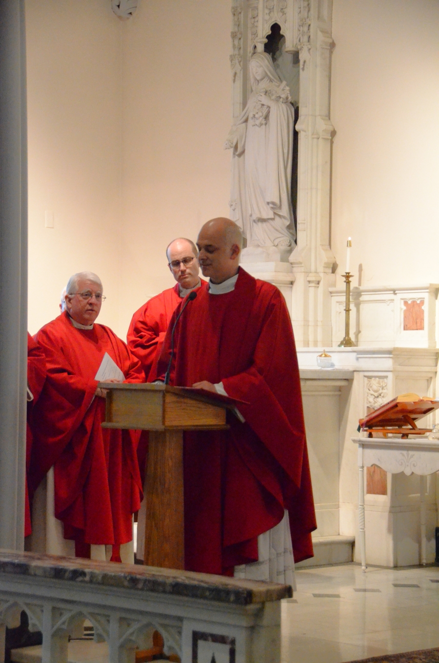 priest speaking on altar