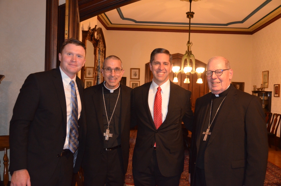 group of 4 men at reception