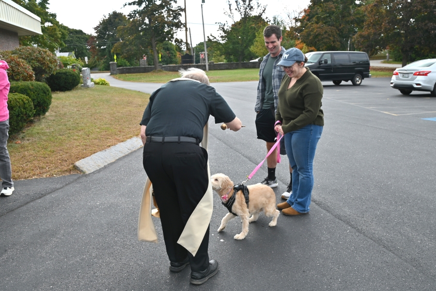 Father Michalowski blessing a dog.