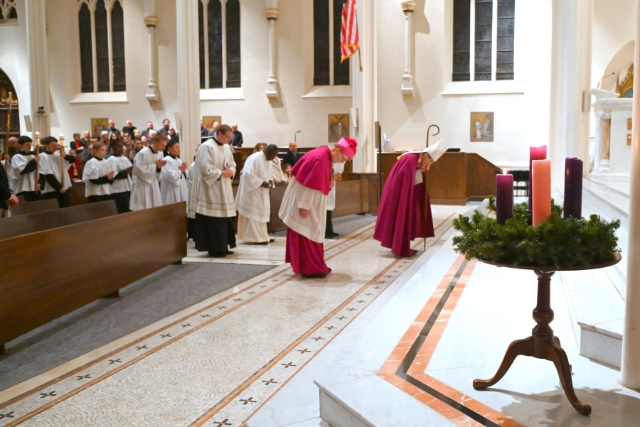 Bishop Ruggieri, Bishop Deeley and others bow before the altar as they prepare for the recessional.