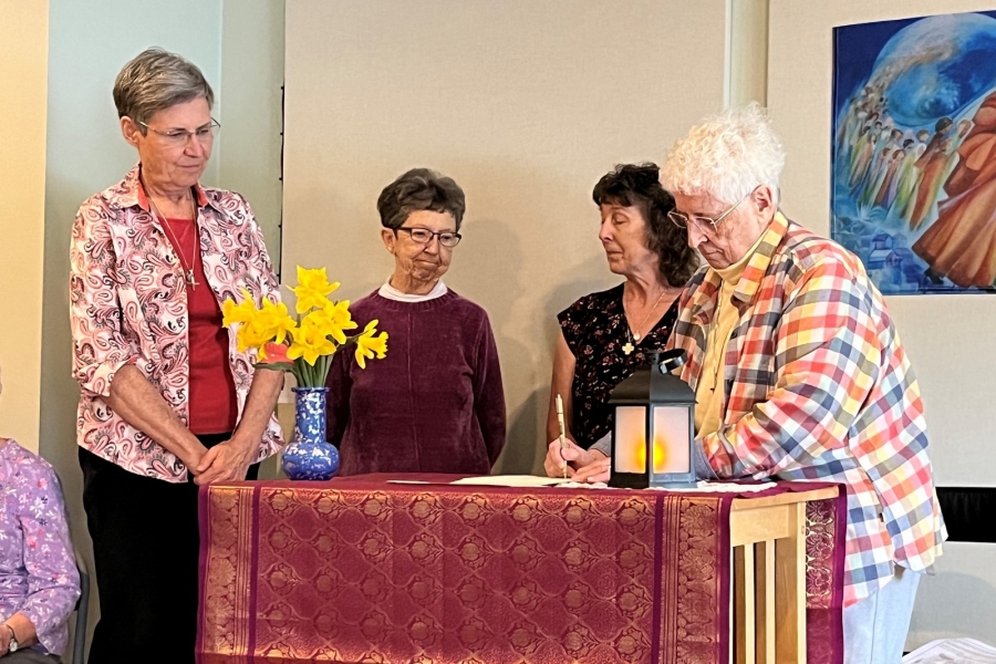 A sister signs the covenant agreement.