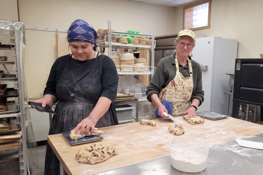 Emily Goepel and Janet Brackett dividing the loaves