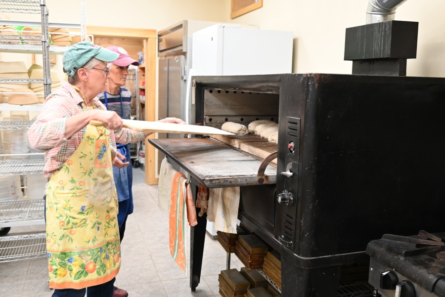 Mariette Castonguay takes bread out of the oven.