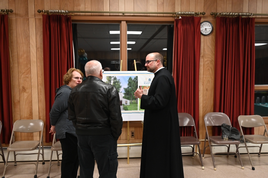 Priest speaking to a couple