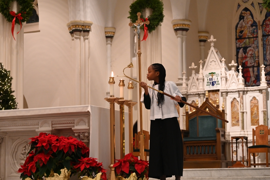 Altar server lights candle