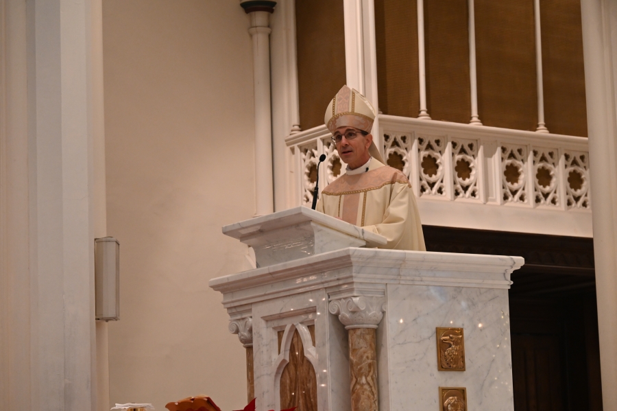 Bishop speaks at the podium