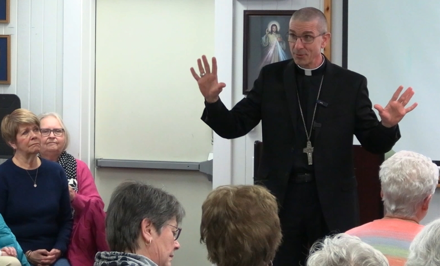 Bishop speaks to a group