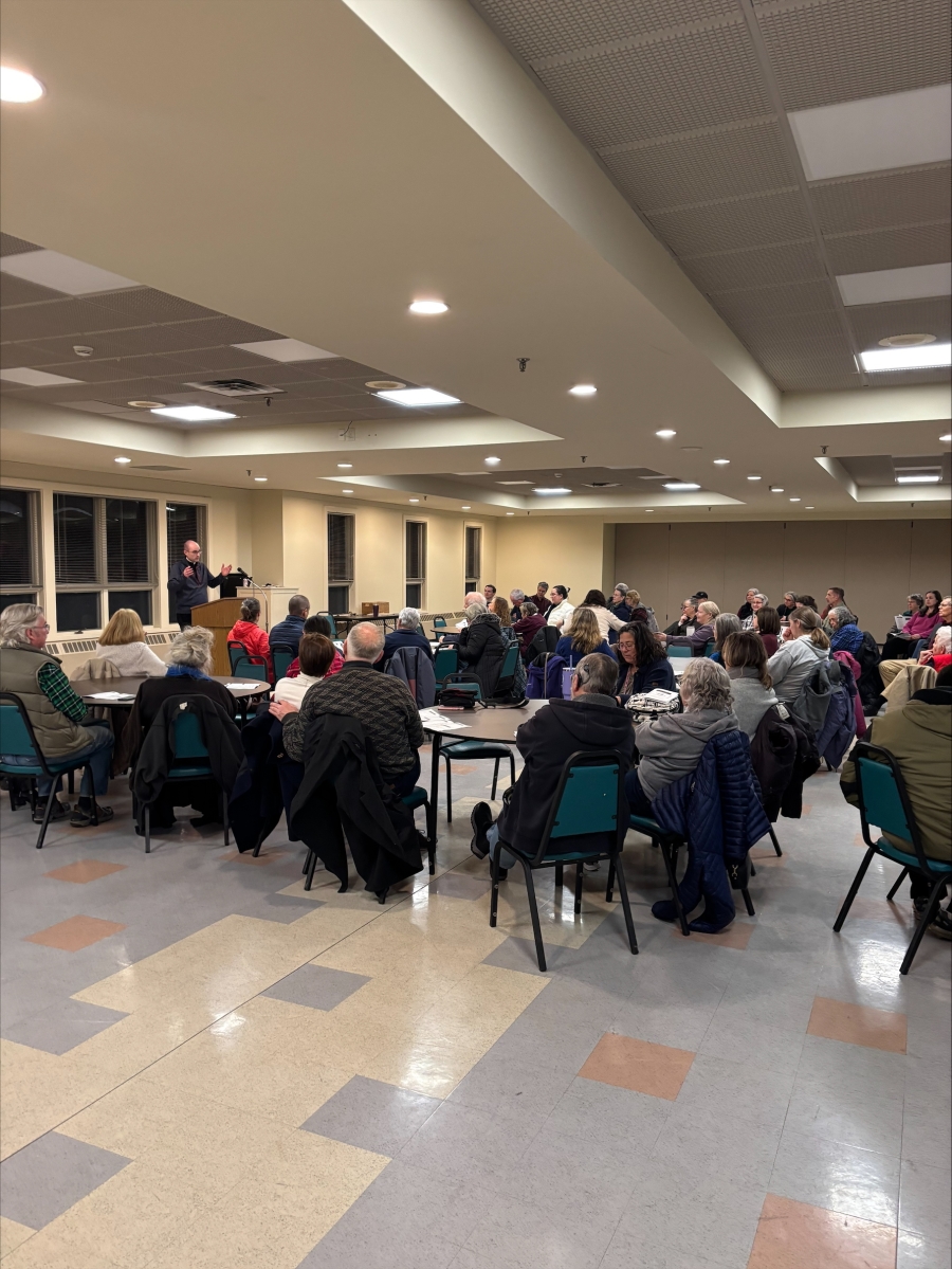 Group at tables listen to speaker