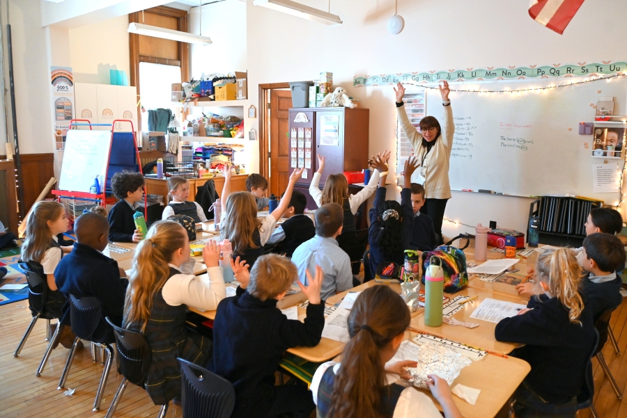 Barbara Vassallo teaches hymns to second graders.