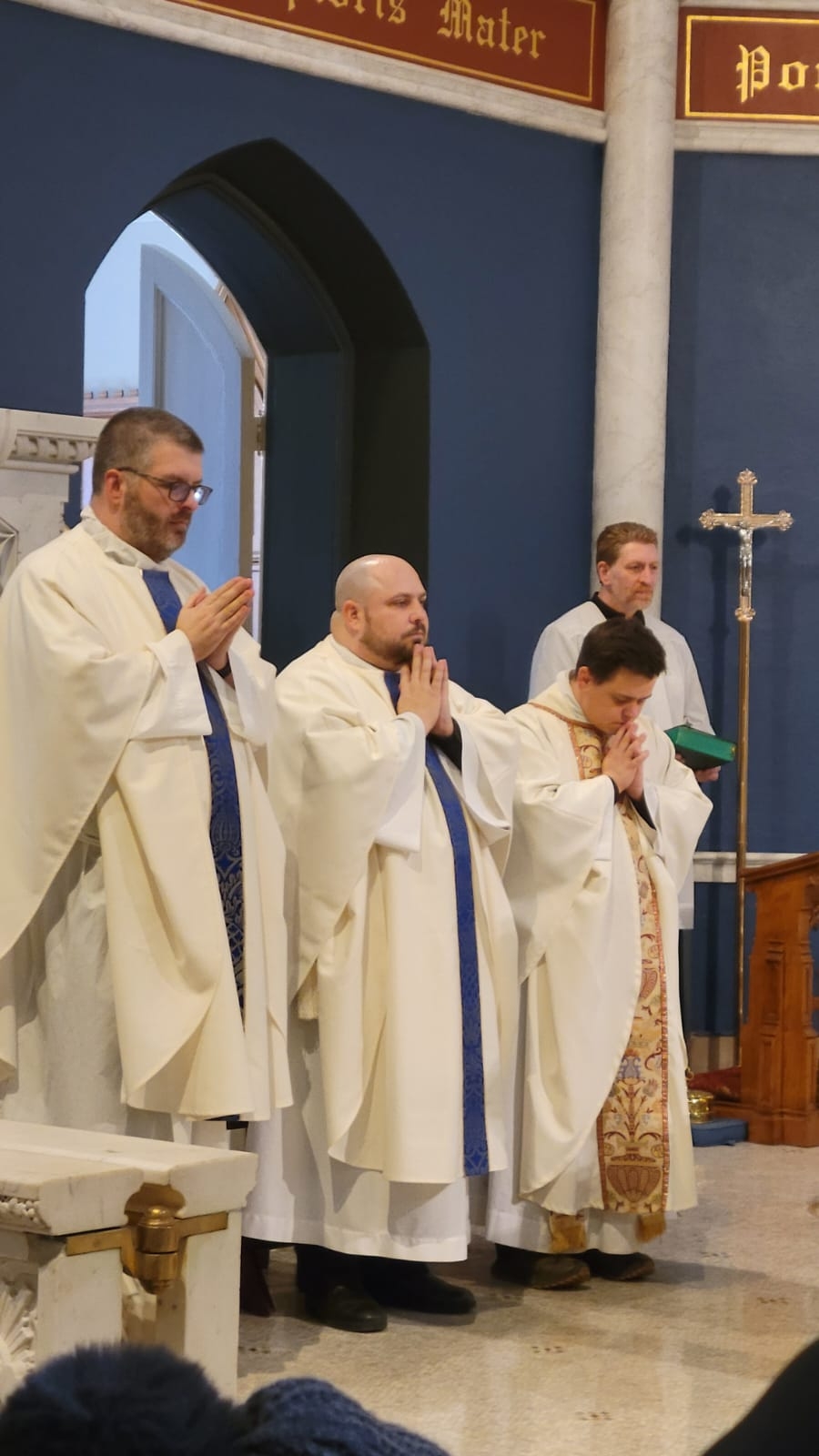 Four priests standing in a row