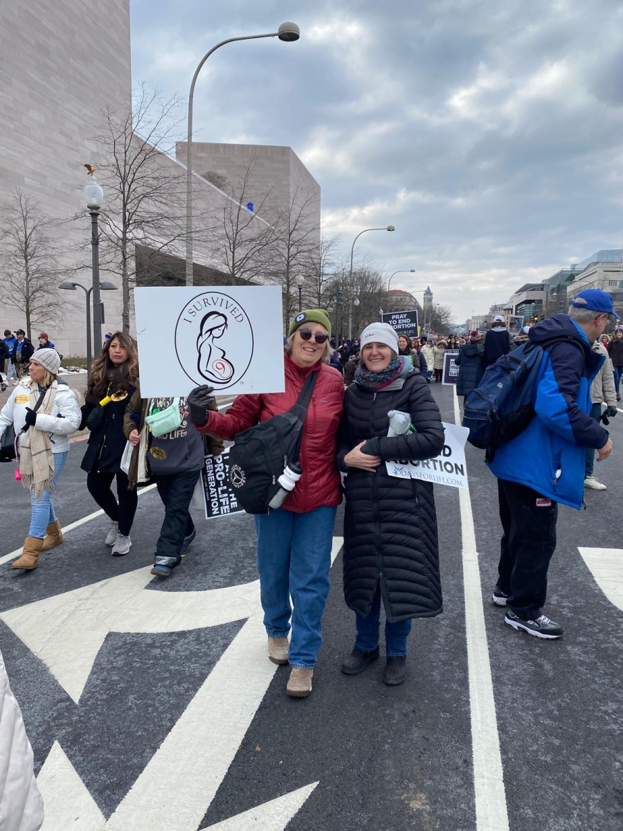 Group walking holding signs 