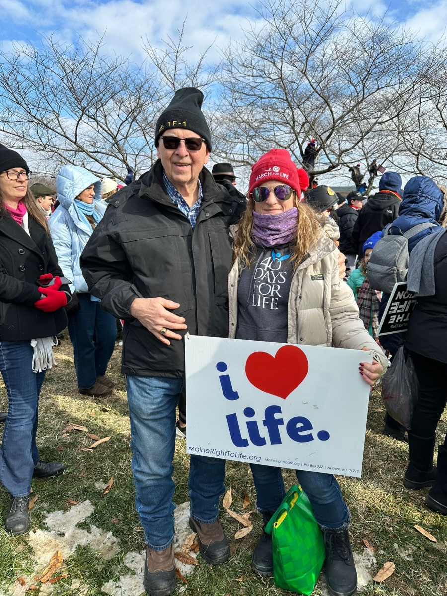 Couple holding a sign