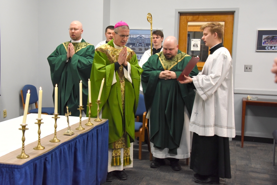 Bishop Ruggieri, Father Kyle Doustou, Father Brad Morin, and Joseph Beale