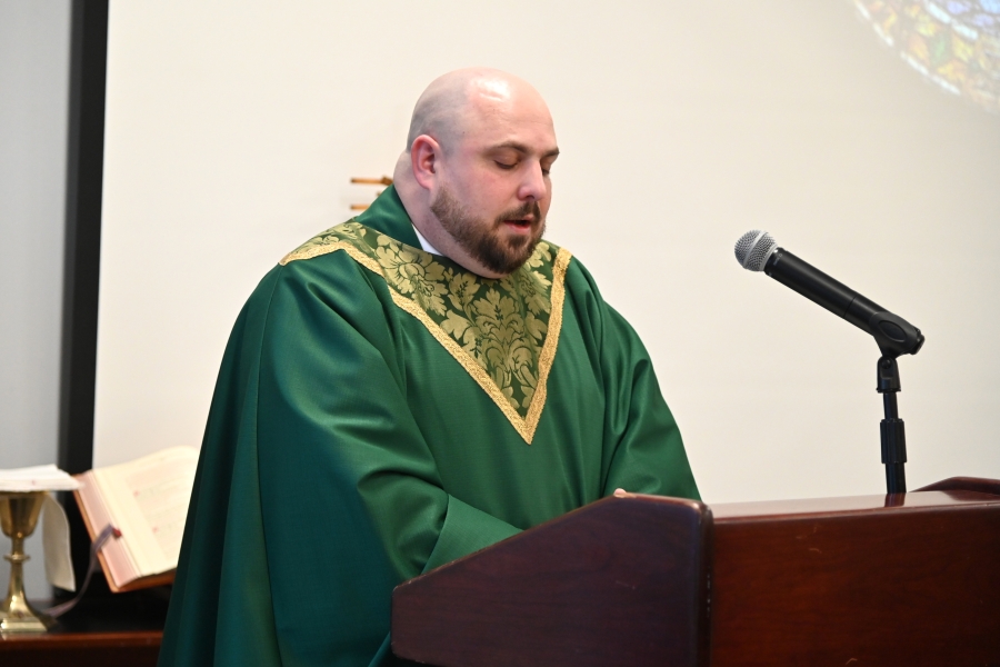 Father Brad Morin reads the Gospel.