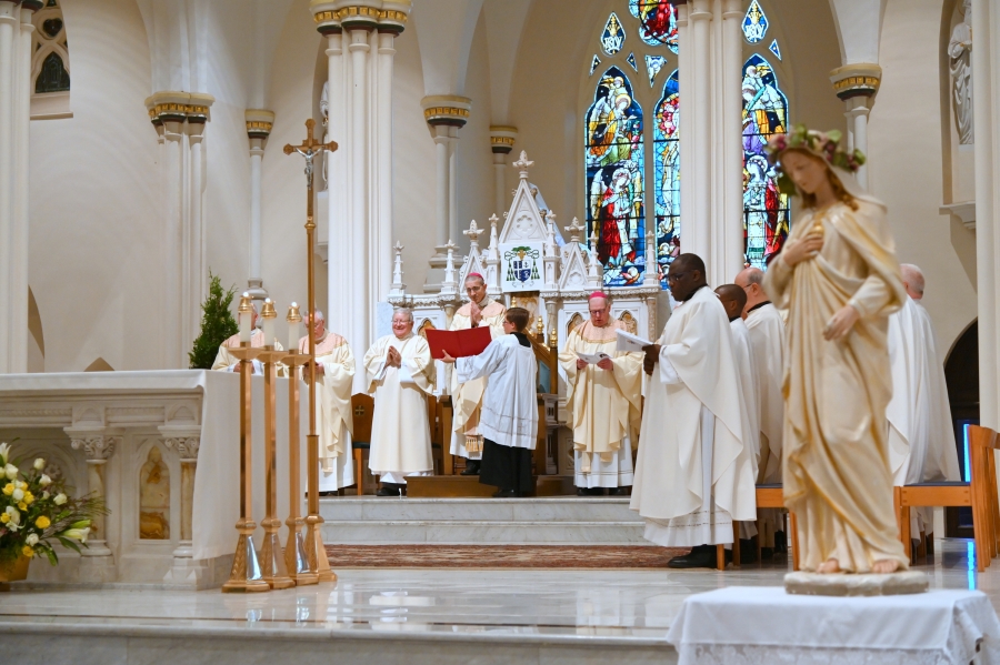 Bishop Ruggieri at the cathedra with priests around him.