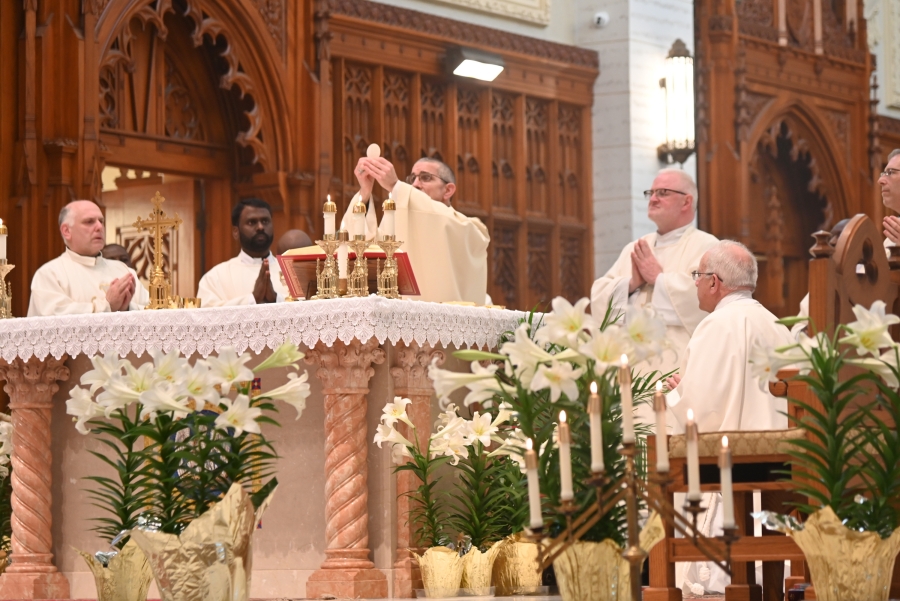 Bishop Ruggieri raises the host during the celebration of the Eucharist