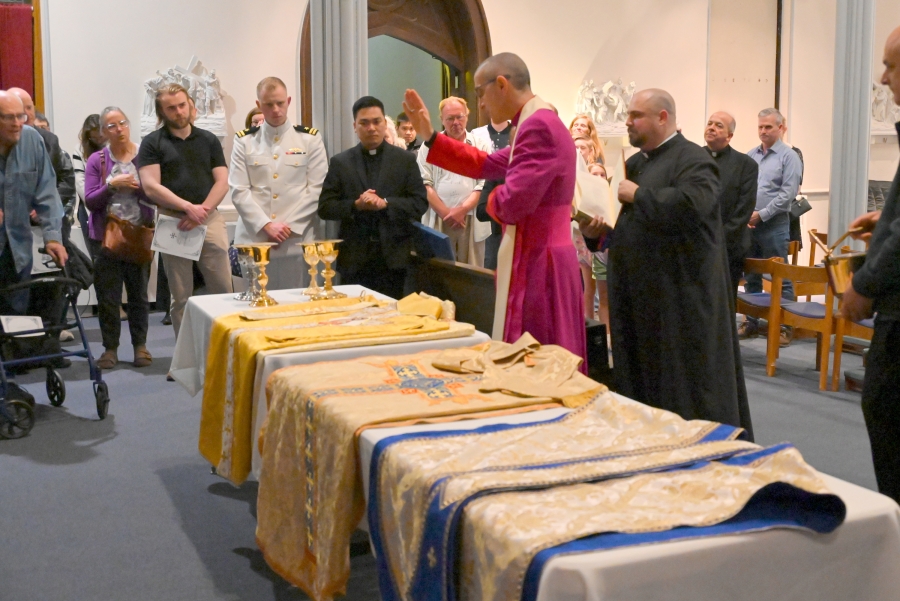 Bishop James Ruggieri blesses chalices.