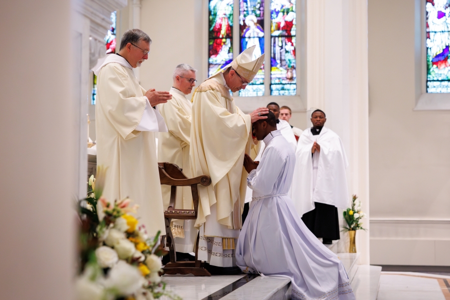 Bishop James Ruggieri lays hands on Evans Yongyee.